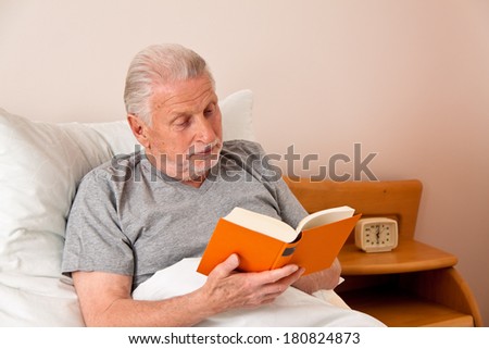a senior in the nursing home during book reading in bed