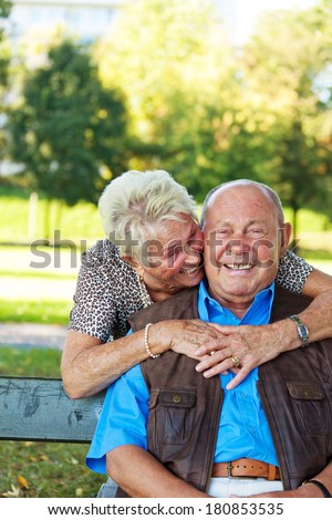 elderly seniors couple in love. man hands over a rose.