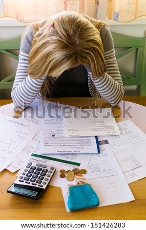 a woman with unpaid bills has many debts. unemployment and personal bankruptcy