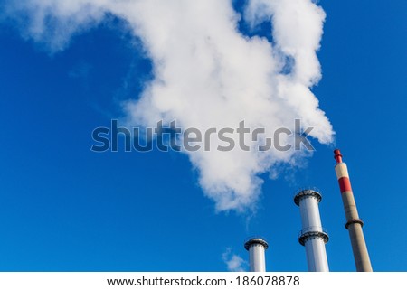 chimney of an industrial company with a strong smoke. symbolic photo for environmental protection and ozone.