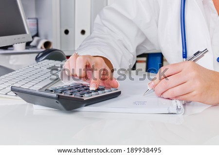 a doctor in the surgery performs administrative work. costs in the doctor's office.