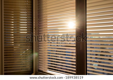 to protect against heat and sun blinds are attached to a window.