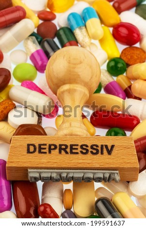 stamp on colorful tablets, symbol photo for depression, therapy and psychotropic drugs