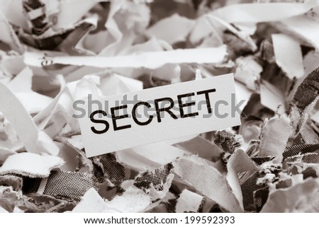 shredded paper tagged with secret, symbol photo for data destruction, banking secrecy and economic espionage