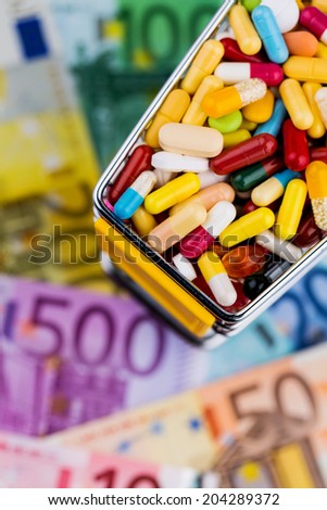tablets, shopping cart, euro bills, symbolic photo for pharmaceuticals, health insurance, health care costs