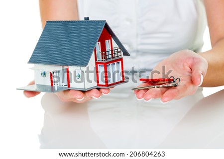a broker for real estate with a house and a key. successful leasing and property for sale by real estate agents.