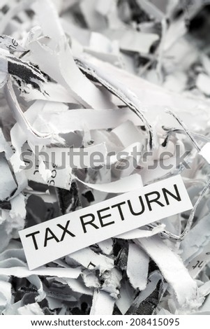 shredded paper tagged with tax return, symbol photo for data destruction, data protection and tax law