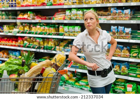 a woman when buying groceries in a supermarket. everyday life of a housewife