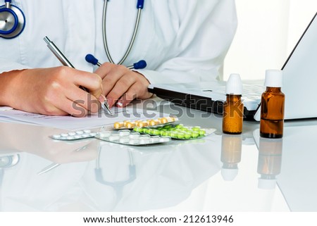 a young doctor prescribes medication. prescription pills are prescribed by the doctor.