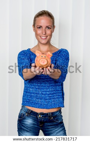 a young woman holding a piggy bank in her hand. , create photo icon for save money and retirement.