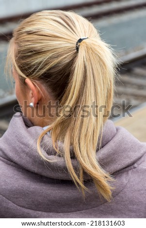 portrait of a thoughtful young woman from behind
