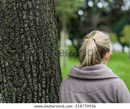 portrait of a thoughtful young woman from behind