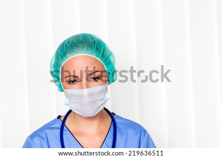 a nurse or doctor in surgical clothes before surgery. symbol photo for stress and overtime at the hospital.