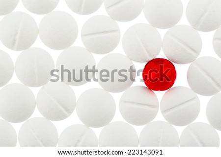 white tablets in contrast with a red tablet, symbol photo for bullying and individuality