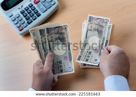 japanese yen notes. hands counting money in japanese currency