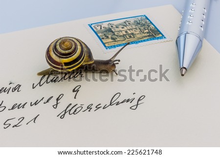 a snail on a letter. symbol photo for slow breifzustellung. smail