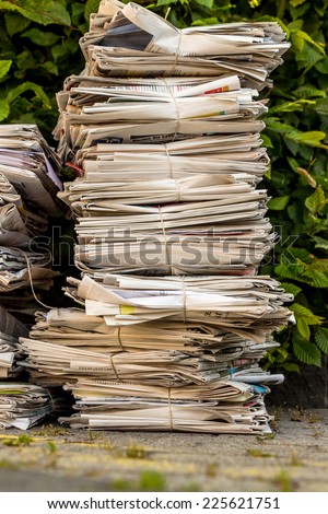 a stack of old newspapers ready for removal by waste paper disposal