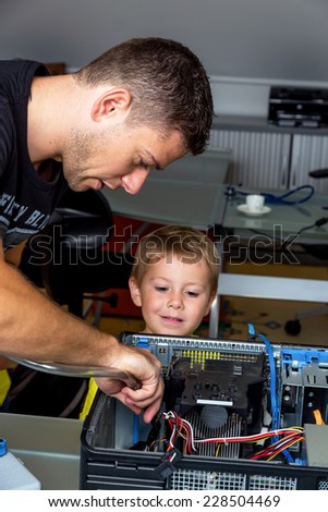 a man repairs a computer in an office