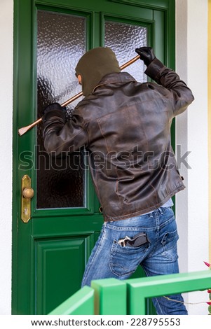 a burglar trying to break a door.