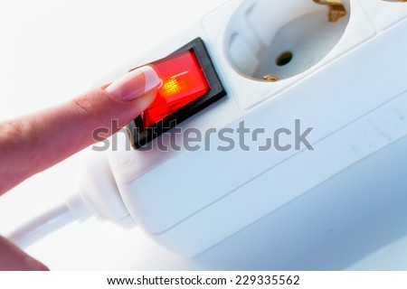 a hand shut off the electric current. photo icon for problems in the energy