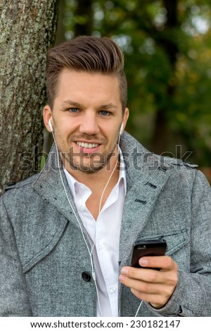a man listening to music on your mobile phone. talking on the mobile phone.
