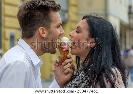 a young couple with a bag of ice. ice cream cones as a refreshment in summer