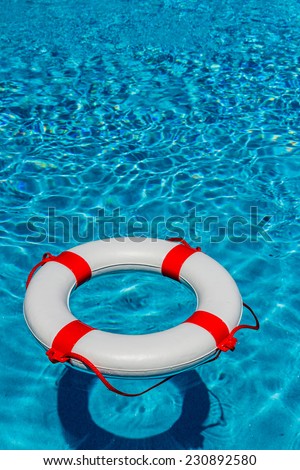 an emergency tire floating in a swimming pool. photo icon for rescue and crisis management in the financial crisis and banking crisis.