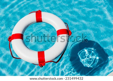 an emergency tire floating in a swimming pool. photo icon for rescue and crisis management in the financial crisis and banking crisis.