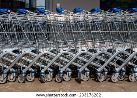 in front of a supermarket shopping carts are ready for customers