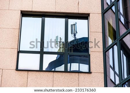 the mobile station of a mobile operator is reflected in a window. mobile transmitter and electromagnetic