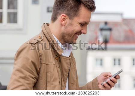 a man writes a text message on his cell phone. communication with a smart phone