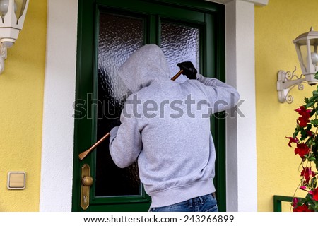 a burglar trying to break a door.