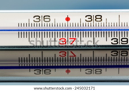 a thermometer is reflected on a glass plate