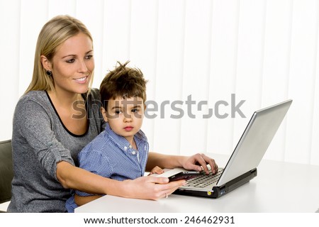 mother and son on the computer, symbol of home, family and career, double burden