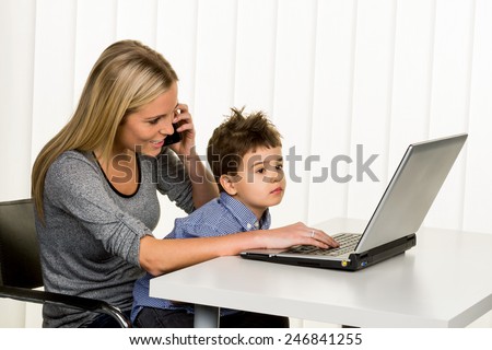 mother and son on the computer, symbol of home, family and career, double burden