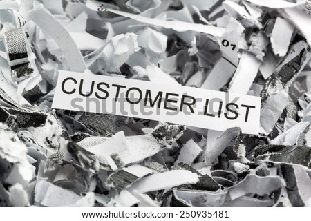 shredded paper tagged with customer list, symbolic photo for data destruction, data protection and customer data