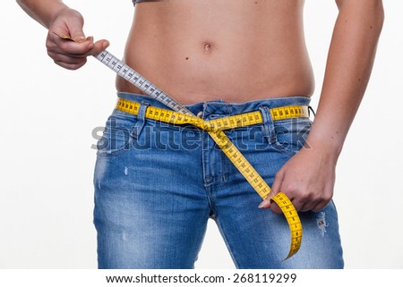a young woman with a tape measure before the next diet. losing weight and fast