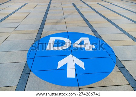 blue arrow on pavement slabs, symbol of orientation, clarity and information