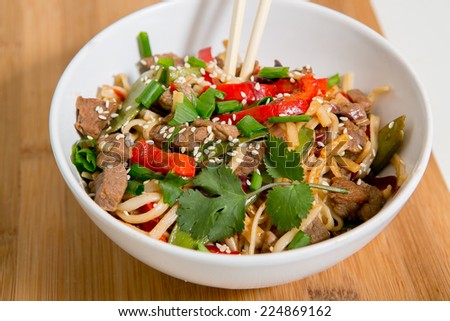 Noodles with beef, peppers, herbs and sesame.