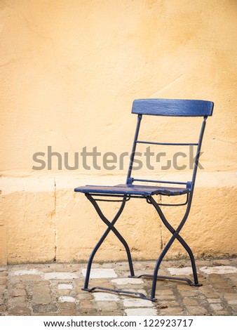 old folding chair at a backyard in rome - nice background with space for text