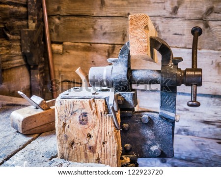 old wood planer and clamp at a workbench