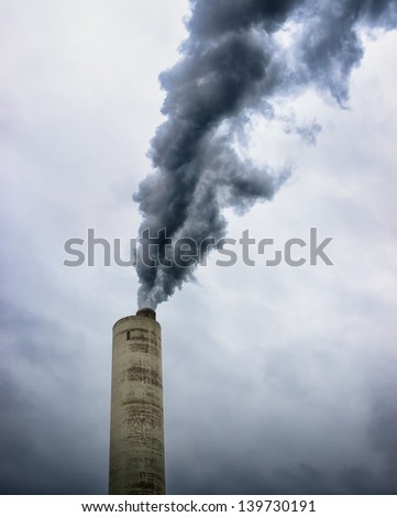 modern industry chimneys in front of gray sky