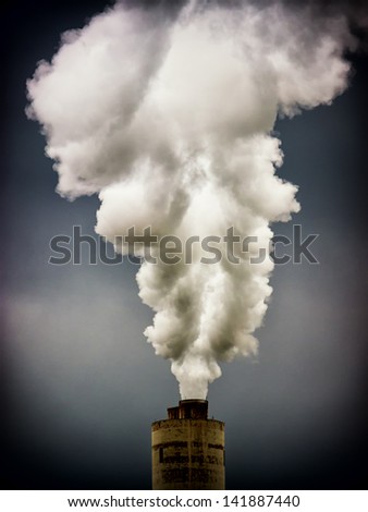 modern industry chimneys in front of gray sky