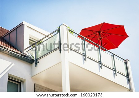 red sunshade at a modern balcony
