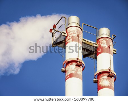 modern industry chimneys in front of blue sky