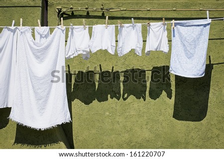 drying clothes in front of an old facade
