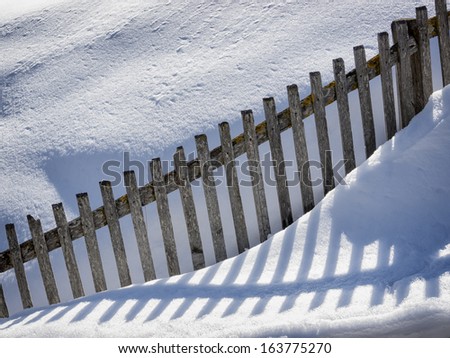 fence in winter with snow