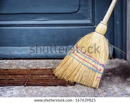 old broom at a door