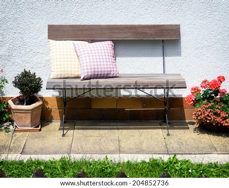 old wooden park bench and cushions