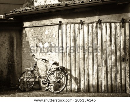 old bike in front of a garage